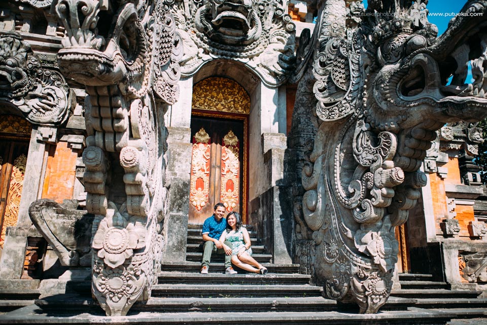 Sit down together in front of big balinese architecture