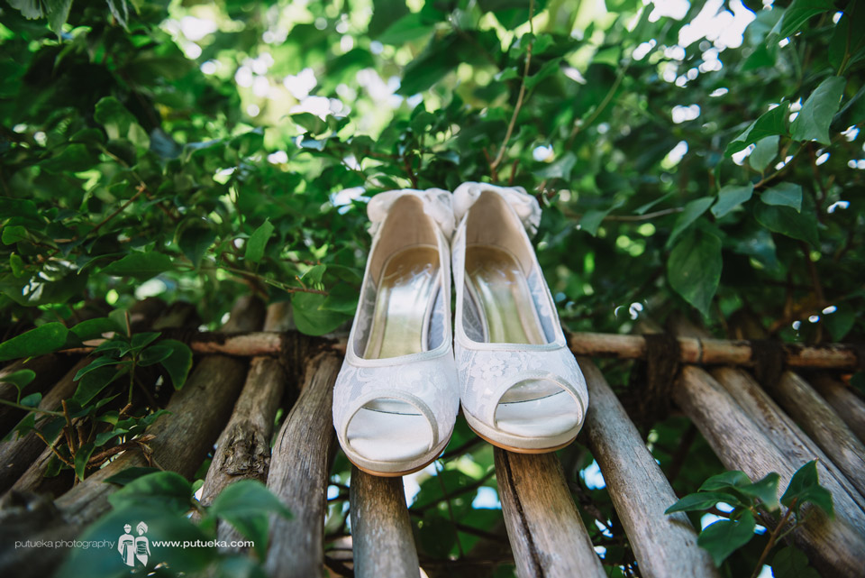 Camille wedding shoes hanging on the wood fence