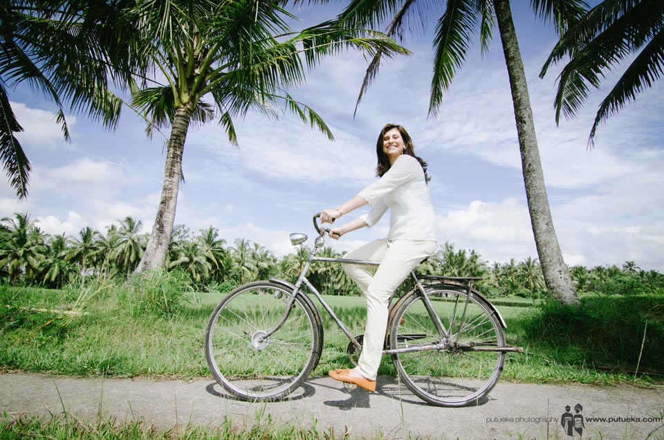 Big smile of mother while riding bicycle