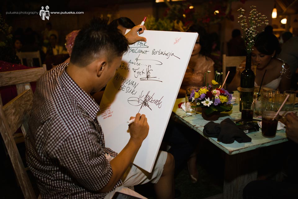 Guest writing congratulation on canvas