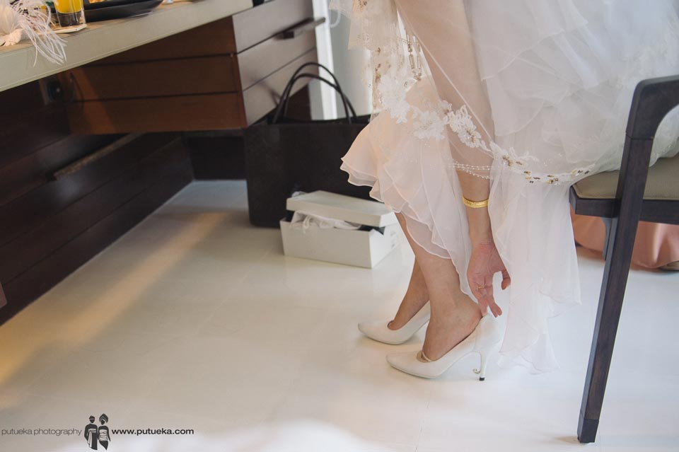 Bride wearing her wedding shoes