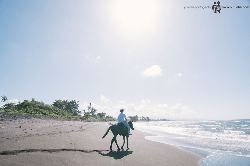 Sun shining when Jasmin Junus riding his horse at the beach