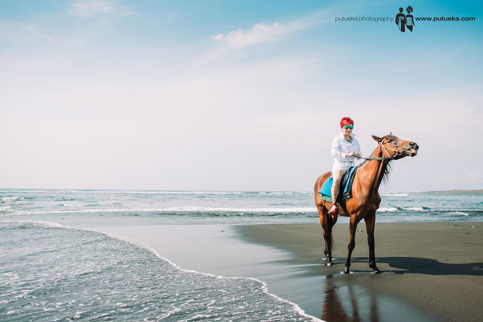 Bali vacation photography with Annie riding horse on the beach