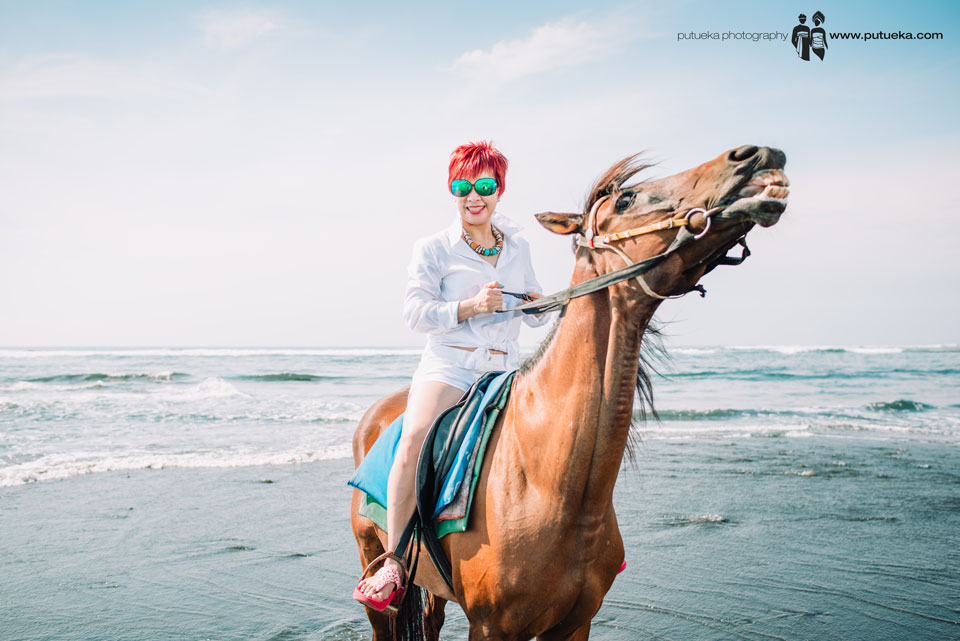 Smile of happiness when riding horse on the beach