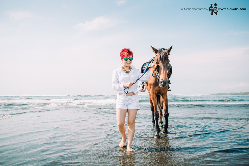 Walking barefoot along the beach with the horse